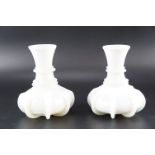 A pair of Victorian milk glass carafes of ringed and ribbed form, height 17 cm