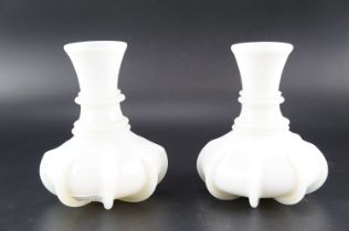A pair of Victorian milk glass carafes of ringed and ribbed form, height 17 cm