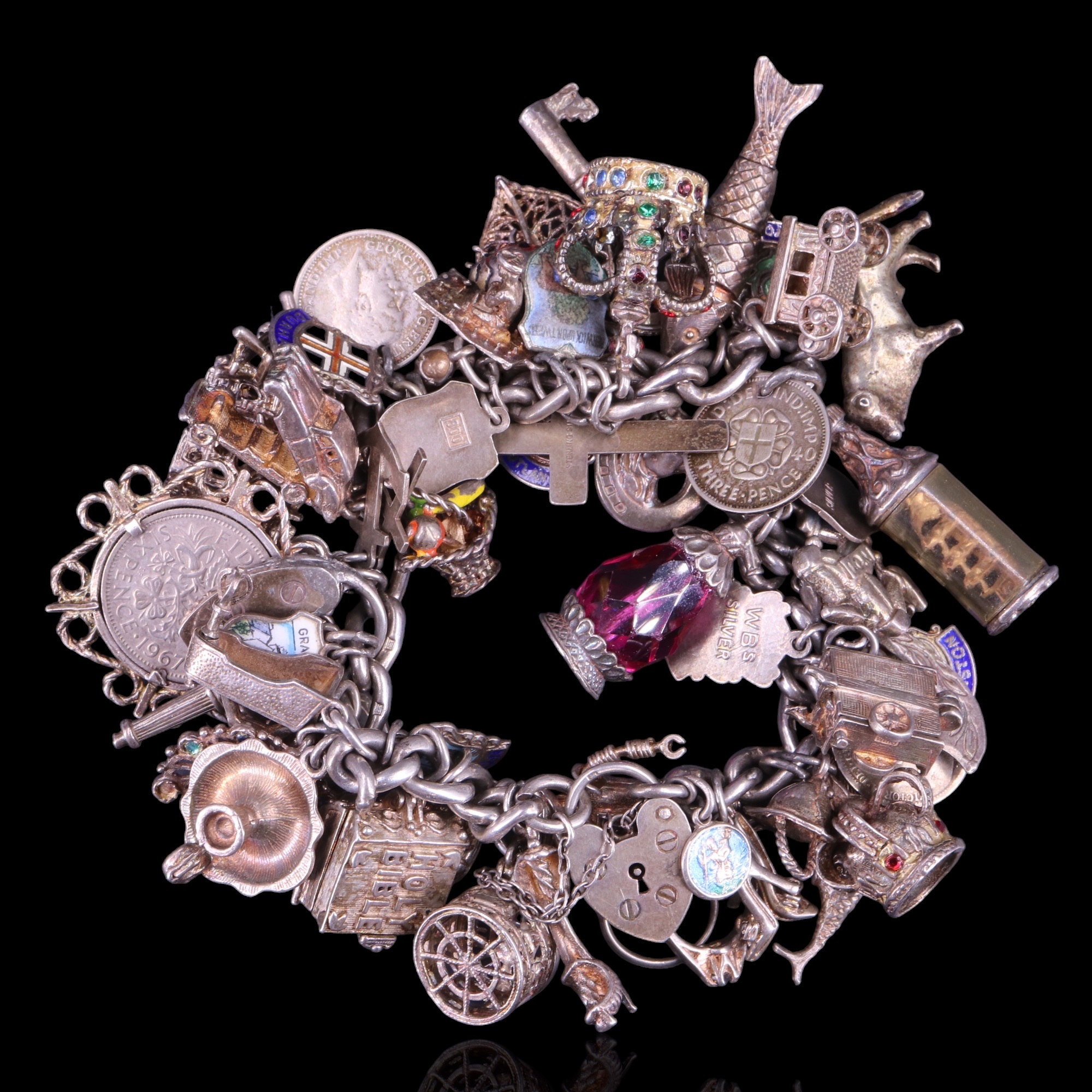 An uncommonly dense vintage silver charm bracelet, 149 g