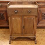 A late 19th / early 20th Century Arts and Crafts influenced oak desk, having a sliding writing