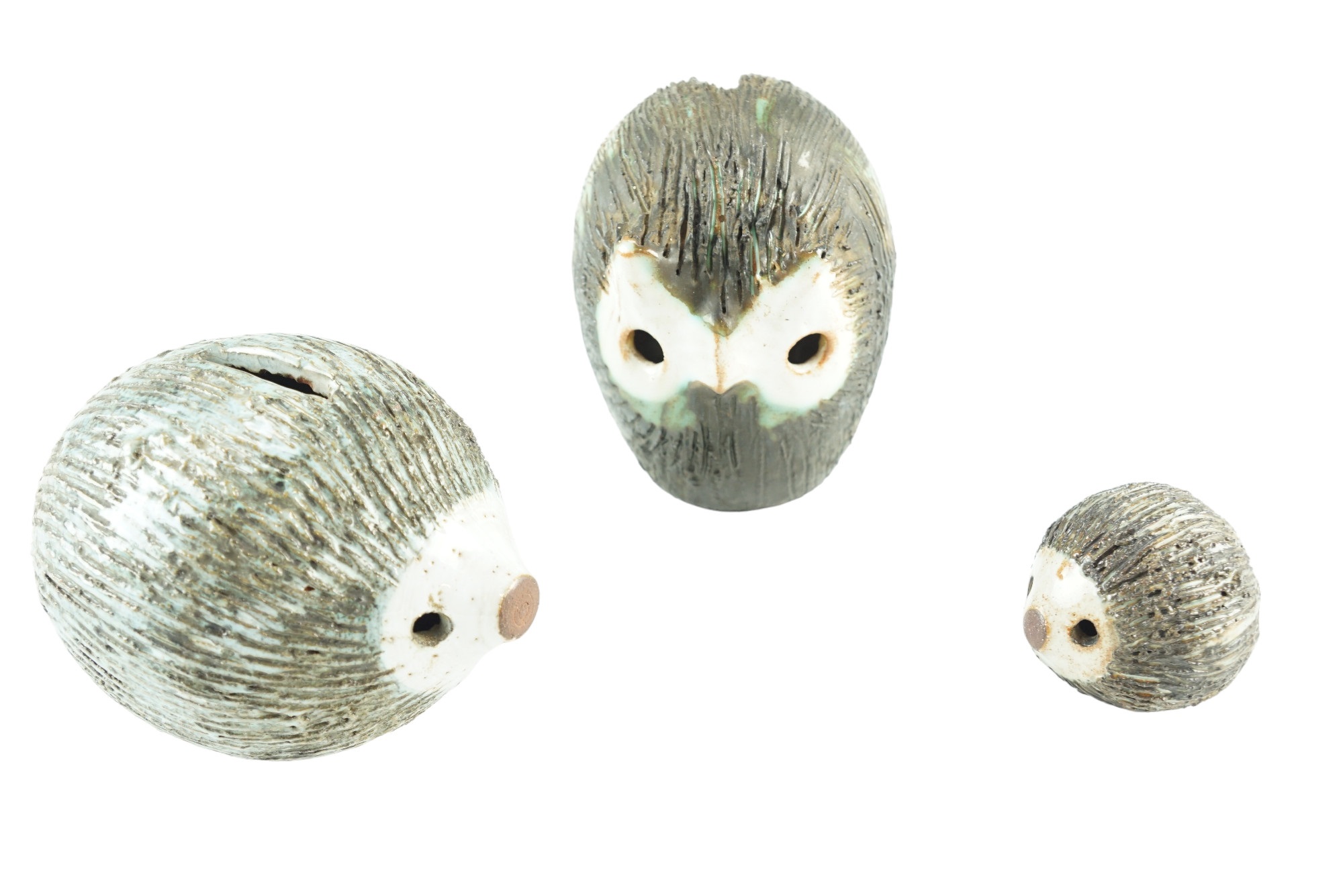 Two Briglin Pottery hedgehogs together with an owl, tallest 11 cm