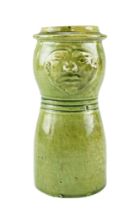 A late 19th / early 20th Century folk art / craft pottery green glazed earthenware mask jug,