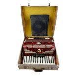 A cased Bell Serino accordion and sheet music