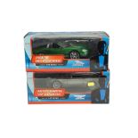 Two boxed James Bond diecast model cars including a Jaguar XKR Roadster and Aston Martin V12