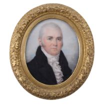 A late Georgian portrait miniature of a mature gentleman with piercing blue eyes, wearing a high-
