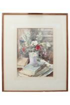 Percy Hague Jowett (1882-1955) A still life of a vase of flowers atop a stack of books and papers,