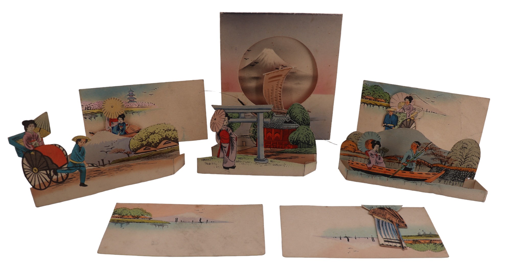 A small group of Japanese printed novelty folding / standing cards depicting figures travelling by