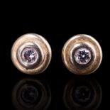 A pair of contemporary diamond boss stud earrings, the round-cut stones each of approx 0.1 cts