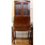 A 1930s elegant and diminutive mahogany bureau bookcase, having slender cabriole legs, 68 cm x 49 cm