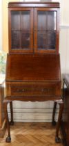 A 1930s elegant and diminutive mahogany bureau bookcase, having slender cabriole legs, 68 cm x 49 cm