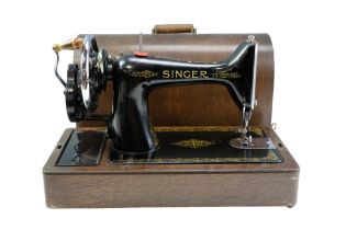 A US 1933 Singer hand-cranked sewing machine in wooden case with key, serial number Y9159320