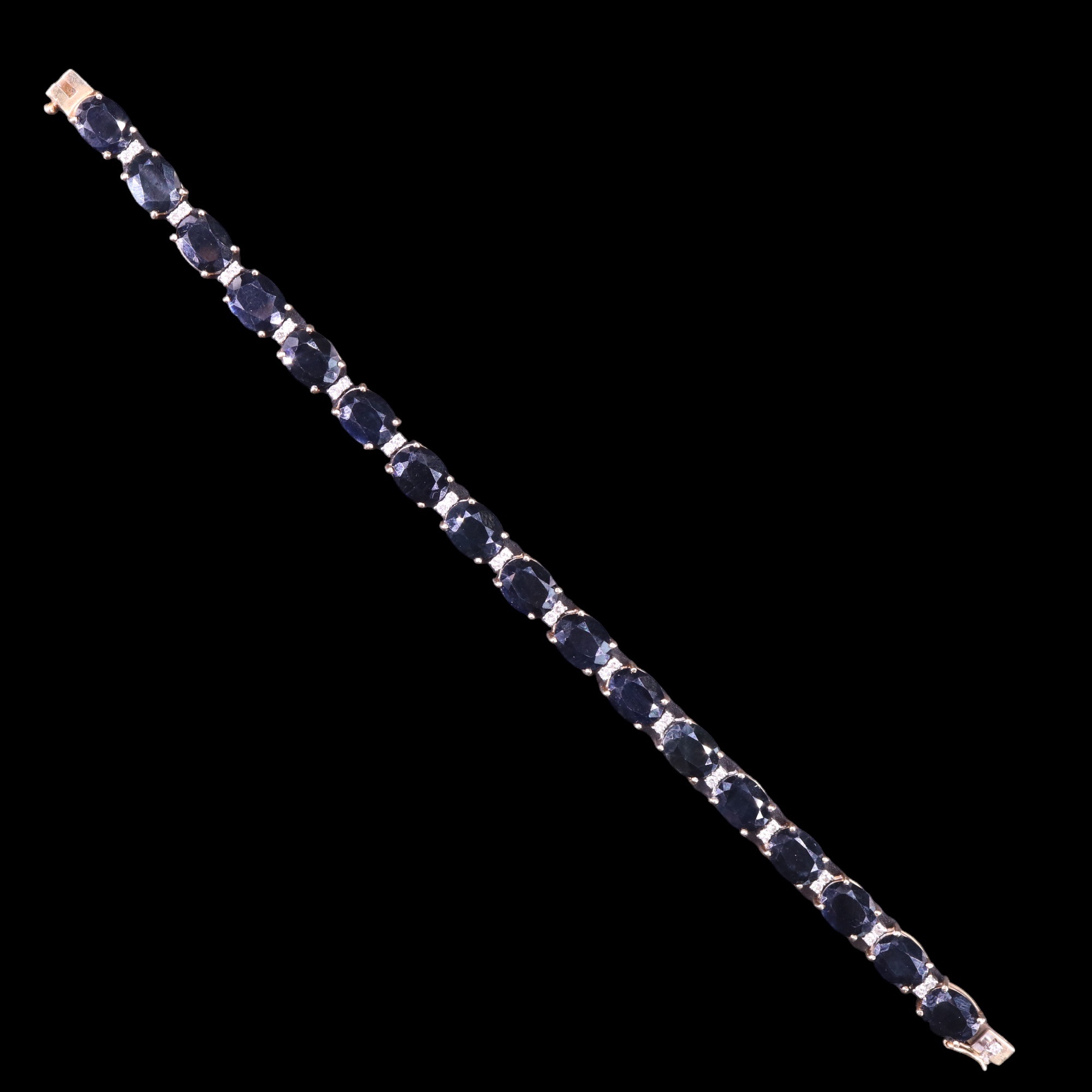 A sapphire and diamond bracelet, comprising seventeen oval-cut sapphires each of approx 2.2 ct, - Image 2 of 4