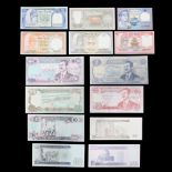 A group of Saddam Hussein Iraq dinar banknotes together with a group of Nepal notes