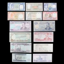 A group of Saddam Hussein Iraq dinar banknotes together with a group of Nepal notes
