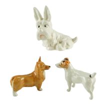 Three Beswick dog figurines comprising a West Highland Terrier (804), a Corgi and a Jack Russel,