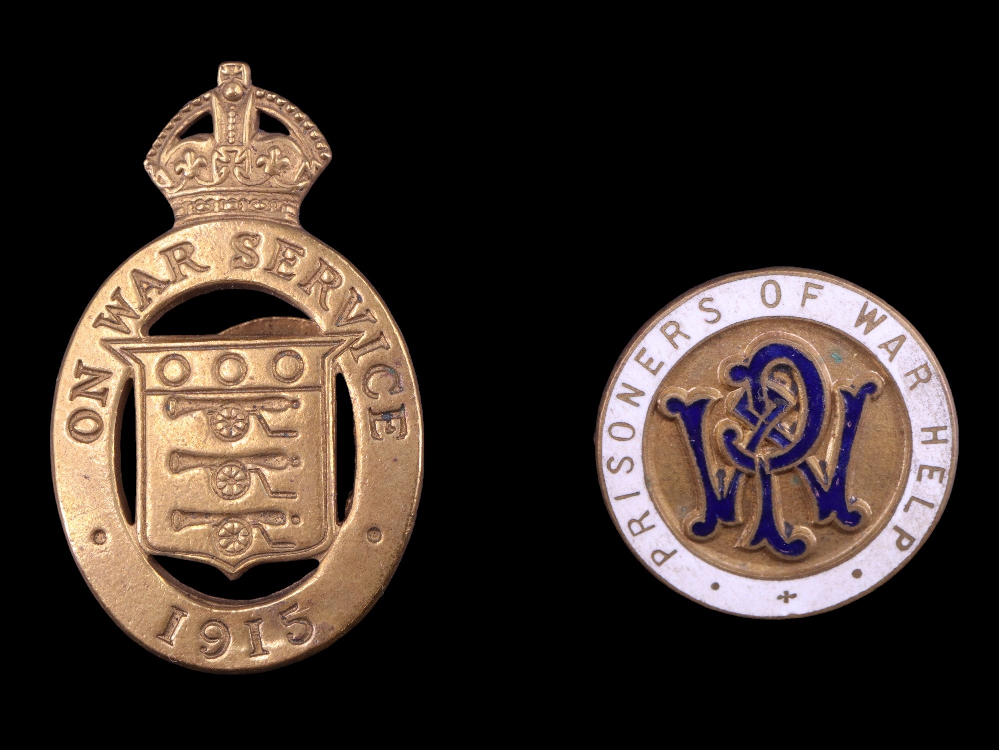 A Great War "Prisoners of War Help" enamelled lapel badge together with a 1915 "On War Service"