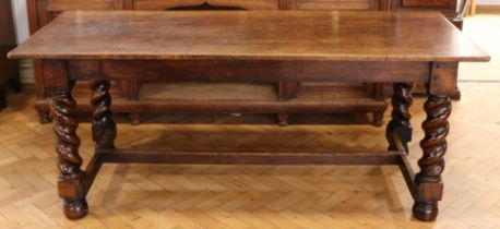 A quality old reproduction oak refectory table, having heavy twist-turned legs united by an H-