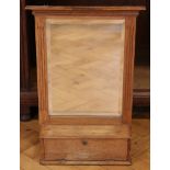 A late 19th / early 20th Century oak wall mirror cum shelf with integral small fall-front cabinet,