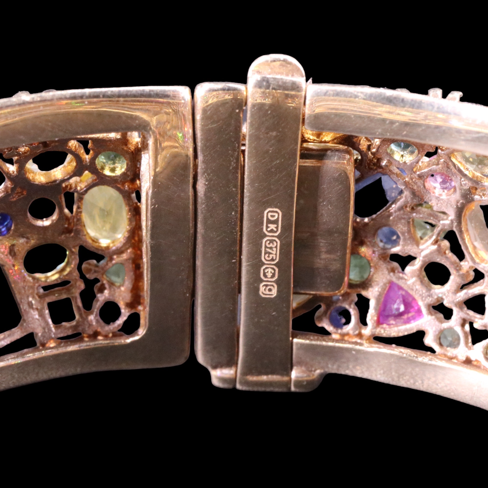 An impressive tutti frutti multi-gem-set 9 ct gold hinged bangle, comprising an open, dense and - Image 3 of 3