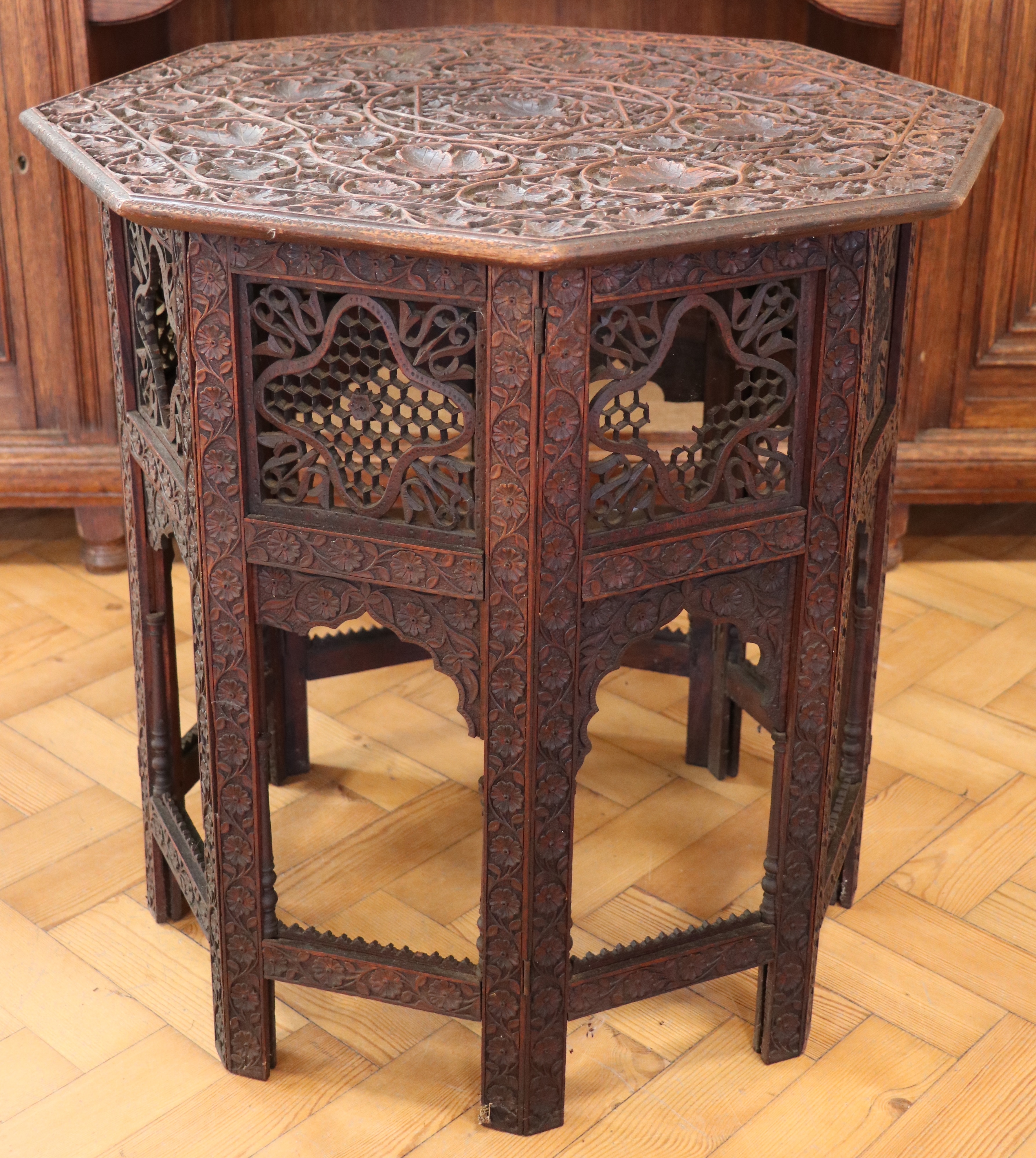 An early 20th Century Indian Hoshiarpur carved wooden folding table, 61 cm x 63 cm high
