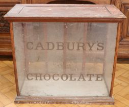 A Victorian Cadbury's Chocolate glazed mahogany countertop display cabinet, having two sliding doors