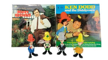 Ken Dodd and the Diddy Men vinyl records together with four figures, tallest 15 cm