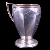 An early 20th Century silver Christening cup, of faceted ovoid form with square-shouldered handle