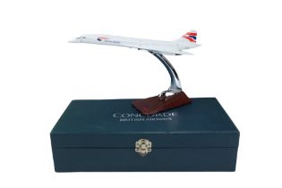A cased diecast British Airways Concorde and stand, underside marked QC, 30.5 cm