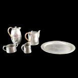 An early 20th Century Civic pewter four-piece tea set and tray, water jug height 16 cm