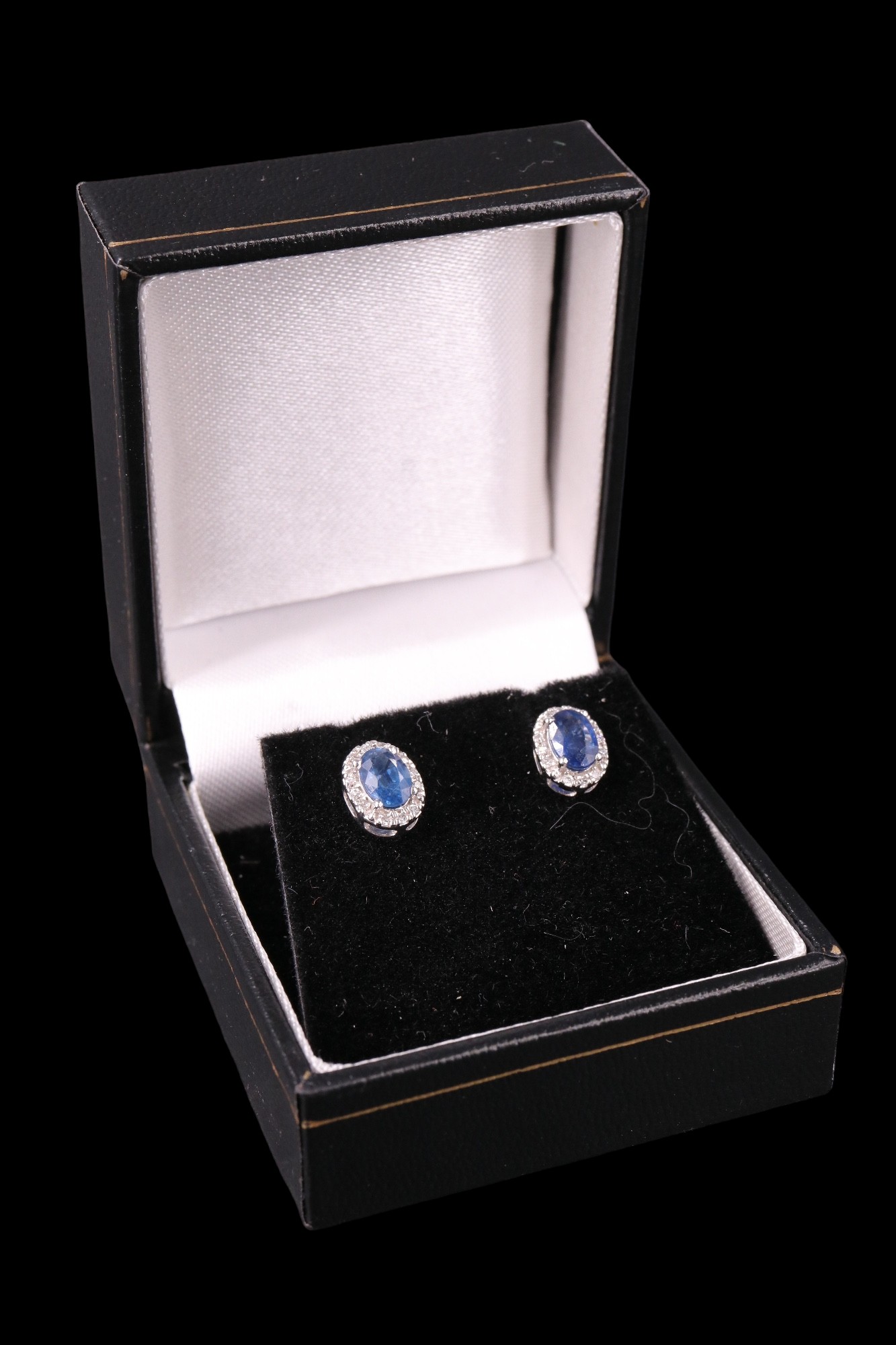 A pair of contemporary sapphire and diamond earrings, each comprising an oval-cut sapphire of approx
