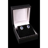 A pair of contemporary sapphire and diamond earrings, each comprising an oval-cut sapphire of approx