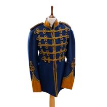 An early 20th Century dress tunic, in blue Melton type fabric with yellow pointed cuffs, frogging