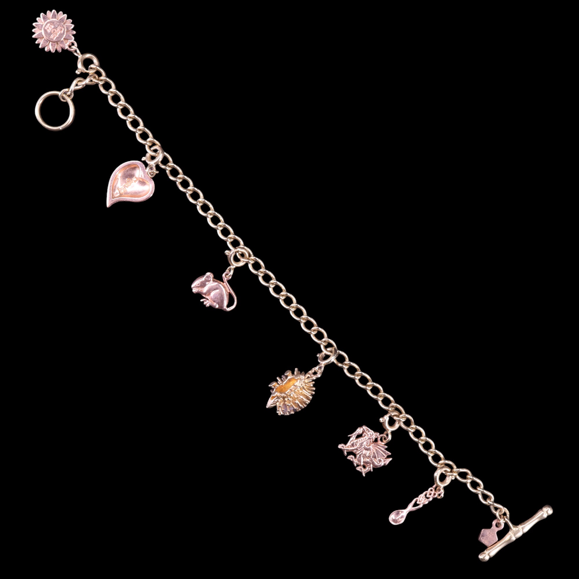 A contemporary Clogau Welsh 9 ct rose and yellow gold charm bracelet, the curb link chain carrying - Image 3 of 5
