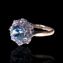 A 1960s pale blue topaz and spinel cluster ring, the central round-cut stone of approx 1 ct, the
