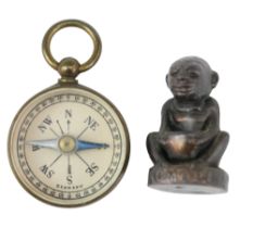 A 1924 Wembley British Empire Exhibition Nomori charm together with a miniature magnetic compass,