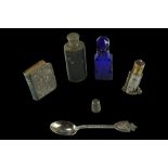 A silver thimble, a cobalt cut glass scent bottle, a small hip flask, a small silver-covered