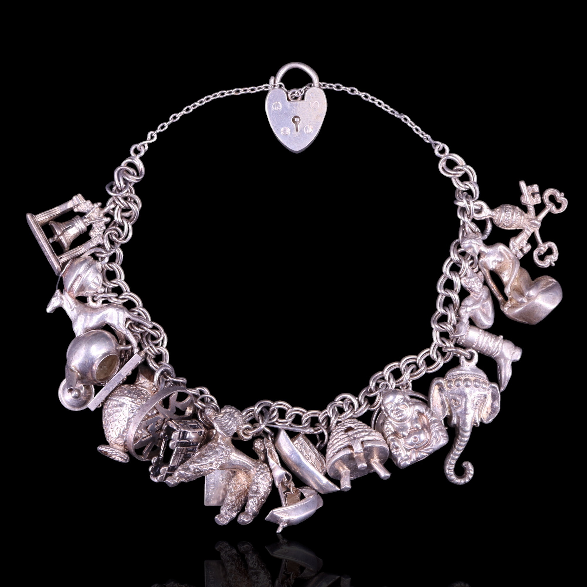 A vintage silver charm bracelet, 65 g