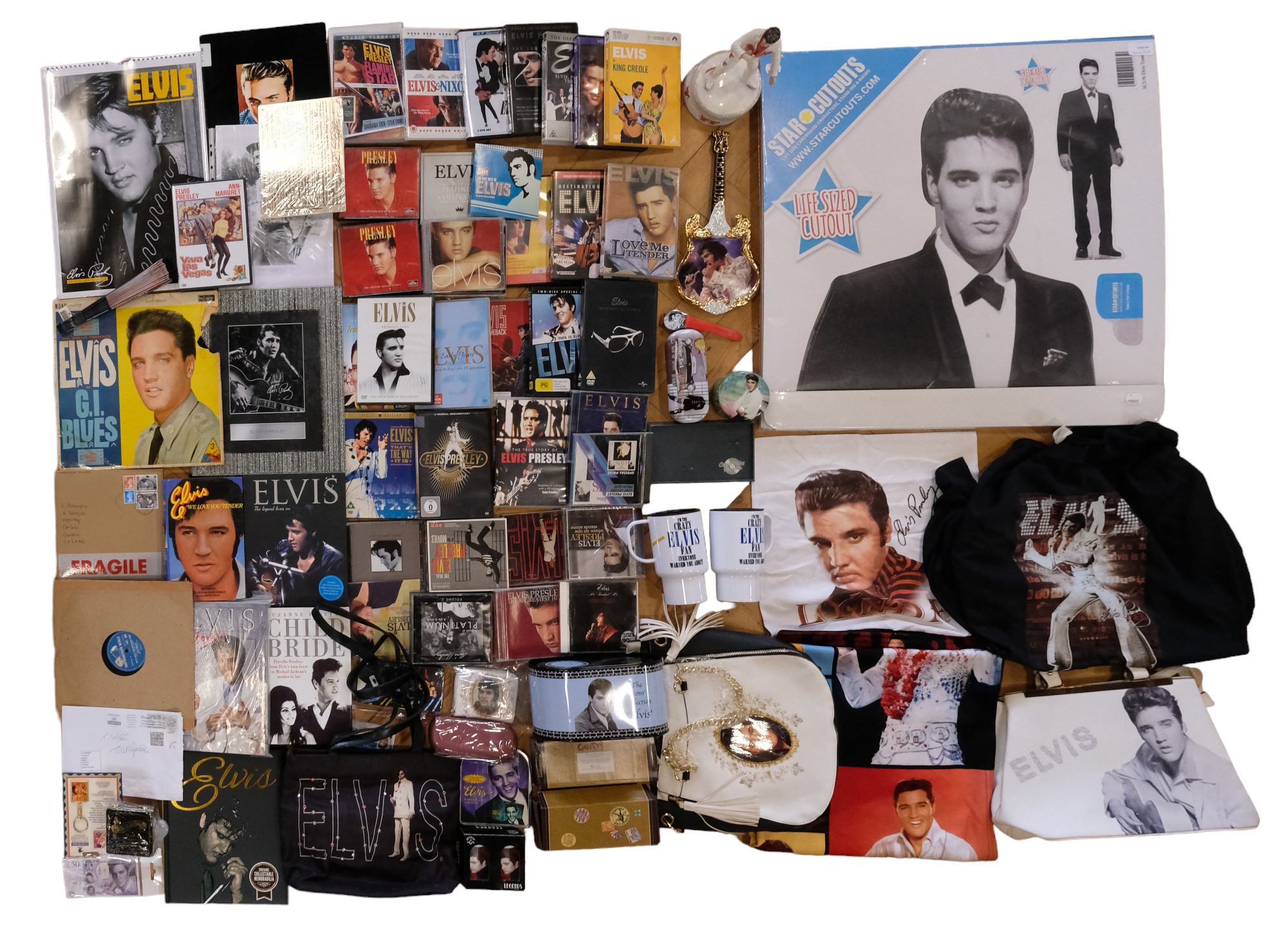 A large collection of Elvis Presley memorabilia including vinyl records, ceramics, CDs, books,