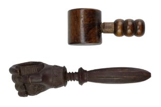 A 19th Century Black Forest style carved wooden screw nutcracker in the form of a hand grasping a