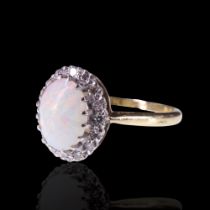 A vintage opal and diamond ring, comprising an oval opal cabochon of approx 9 mm x 7 mm claw-set