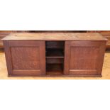 An early 20th Century oak two-door wall cabinet, having a central niche with adjustable shelf, 95 cm