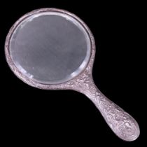 A late 19th / early 20th Century silver-backed hand mirror, length 23.5 cm