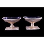 A pair of Victorian silver pedestal salt cellars, each of rounded oblong form with bobbin-moulded