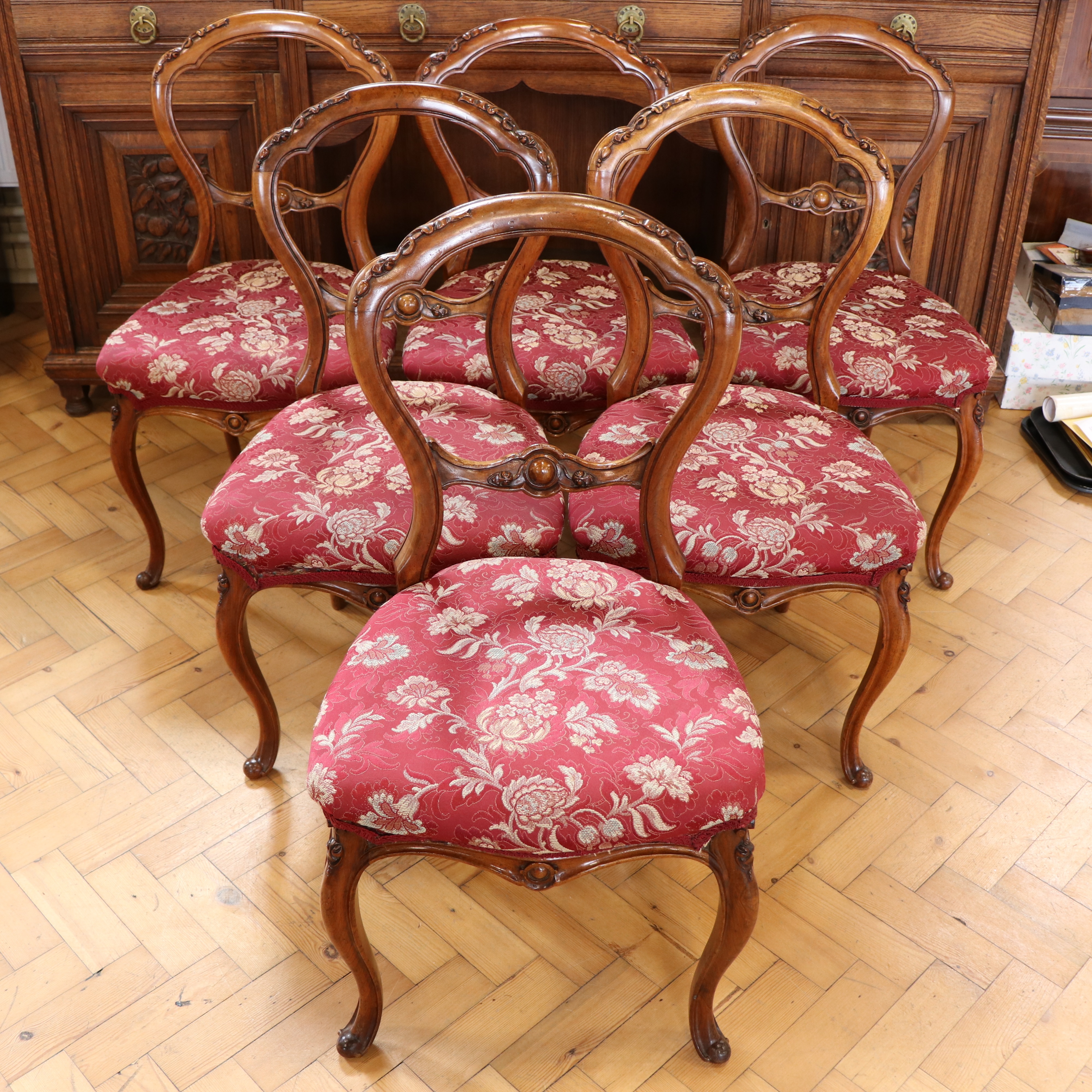 A set of six fine Victorian carved walnut cusped-balloon back dining chairs, (re-upholstered and
