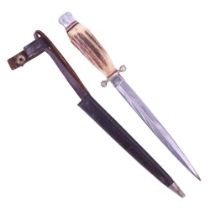 A small German stiletto, having an antler grip and leather scabbard, blade 13 cm, 21 cm overall