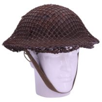 A Second World War British army Mk 2 steel helmet with camouflage net