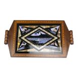 A Brazilian inlaid mahogany butterfly wing tea tray decorated with geometrically reserved silhouette