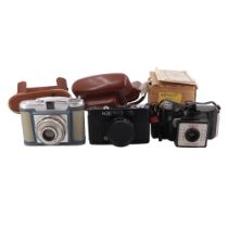 Three cased vintage film cameras comprising a 127 mm Coronet 4-4, a 35 mm Prinz Saturn and a 120mm