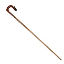 A hand-crafted shepherd's style walking stick, its crook-like walnut handle carved and painted in