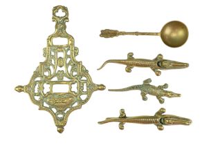 A small group of vintage domestic brassware including a trivet and two novelty nut crackers,